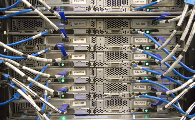 The rear of a server in a networking stack that shows network cables going into it